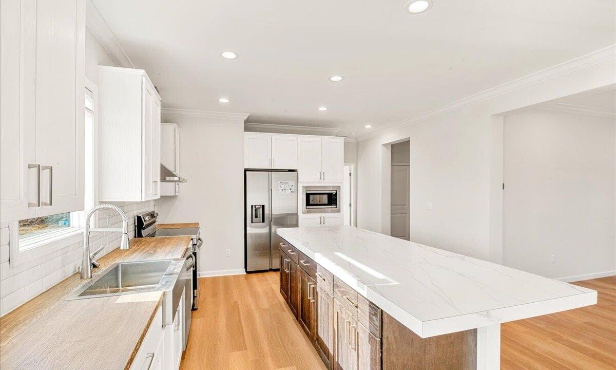 Inside the Redbud Estates model home: island kitchen with stainless appliances, London, Kentucky